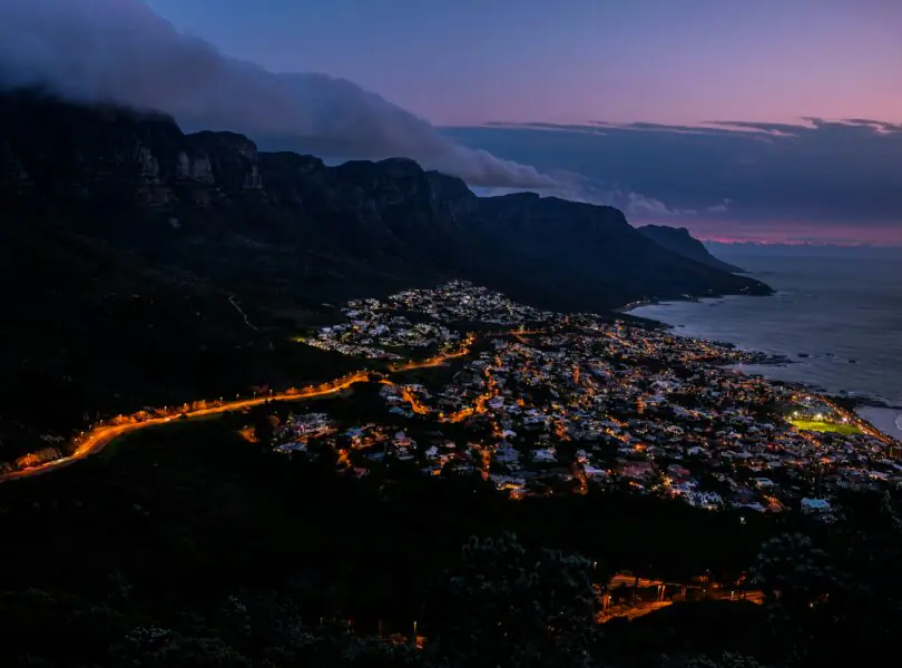 Camps Bay beach and the Twelve Apostles mountains under a clear blue summer sky